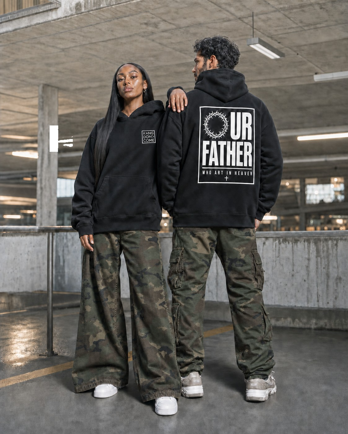 Two people wearing Kingdom Come hoodies, one showing the Our Father back print
