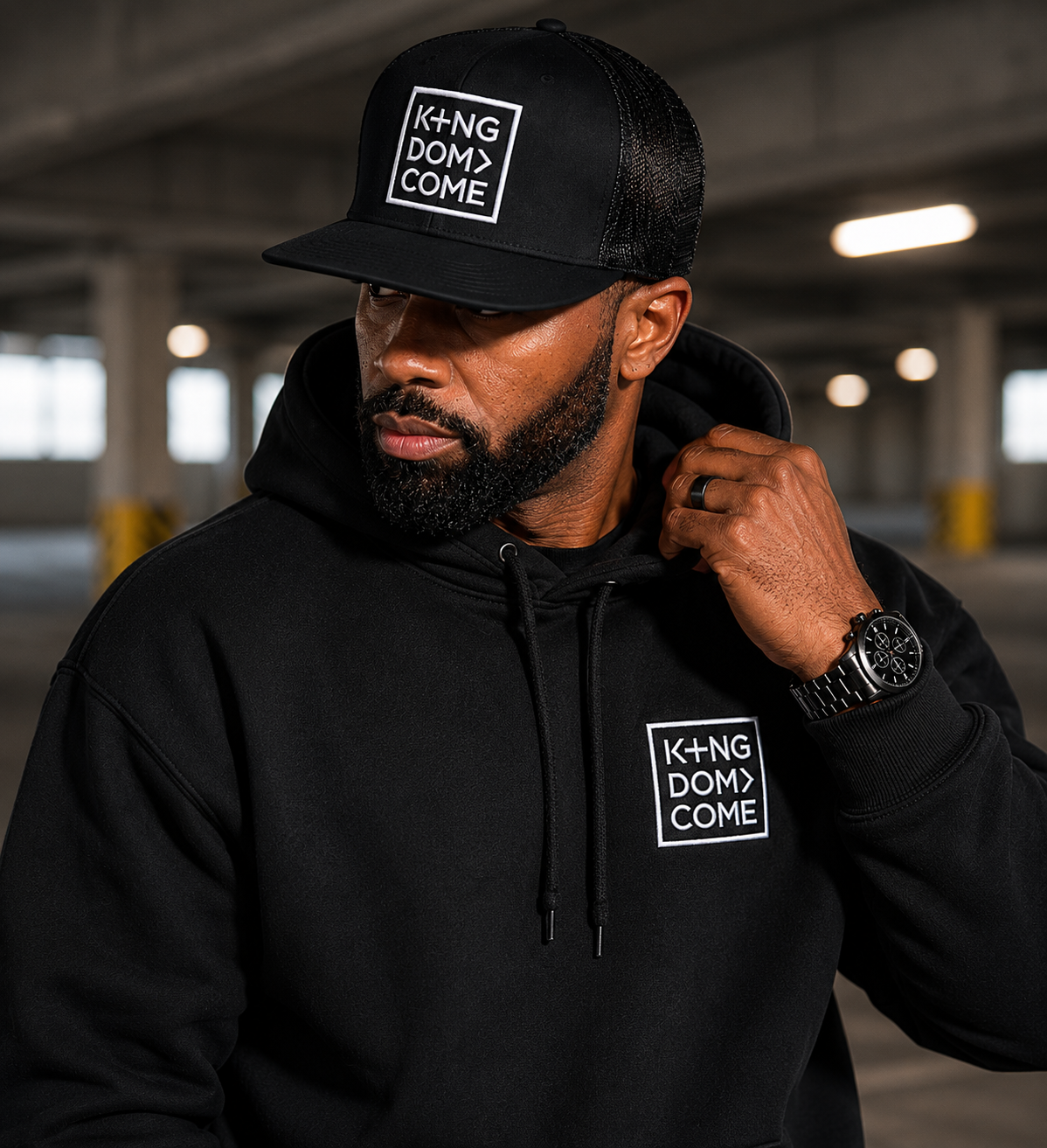 Man wearing the black Kingdom Come embroidered cap